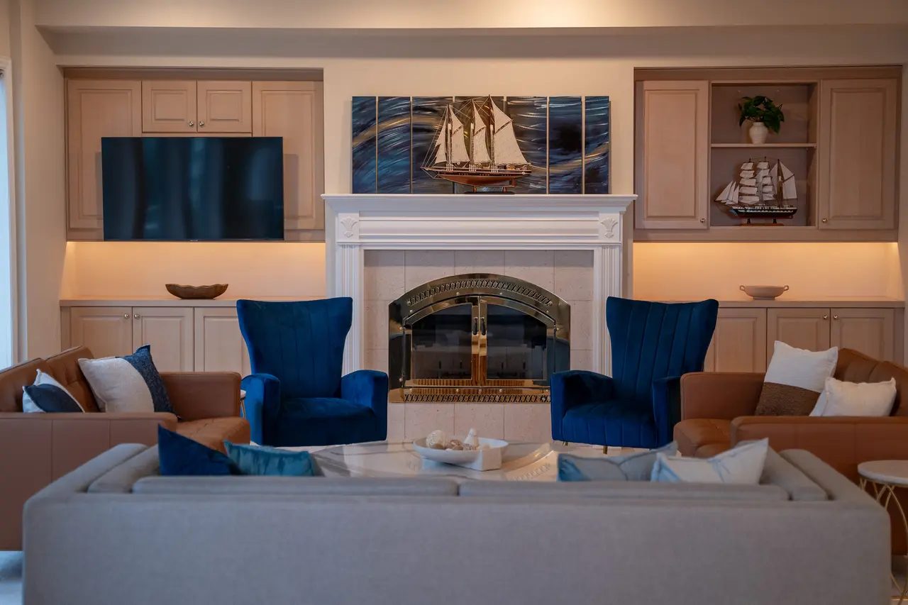 Living room featuring our beautiful (decorative only) stone fireplace. Enjoy the conversation with enough luxury seating for all. 