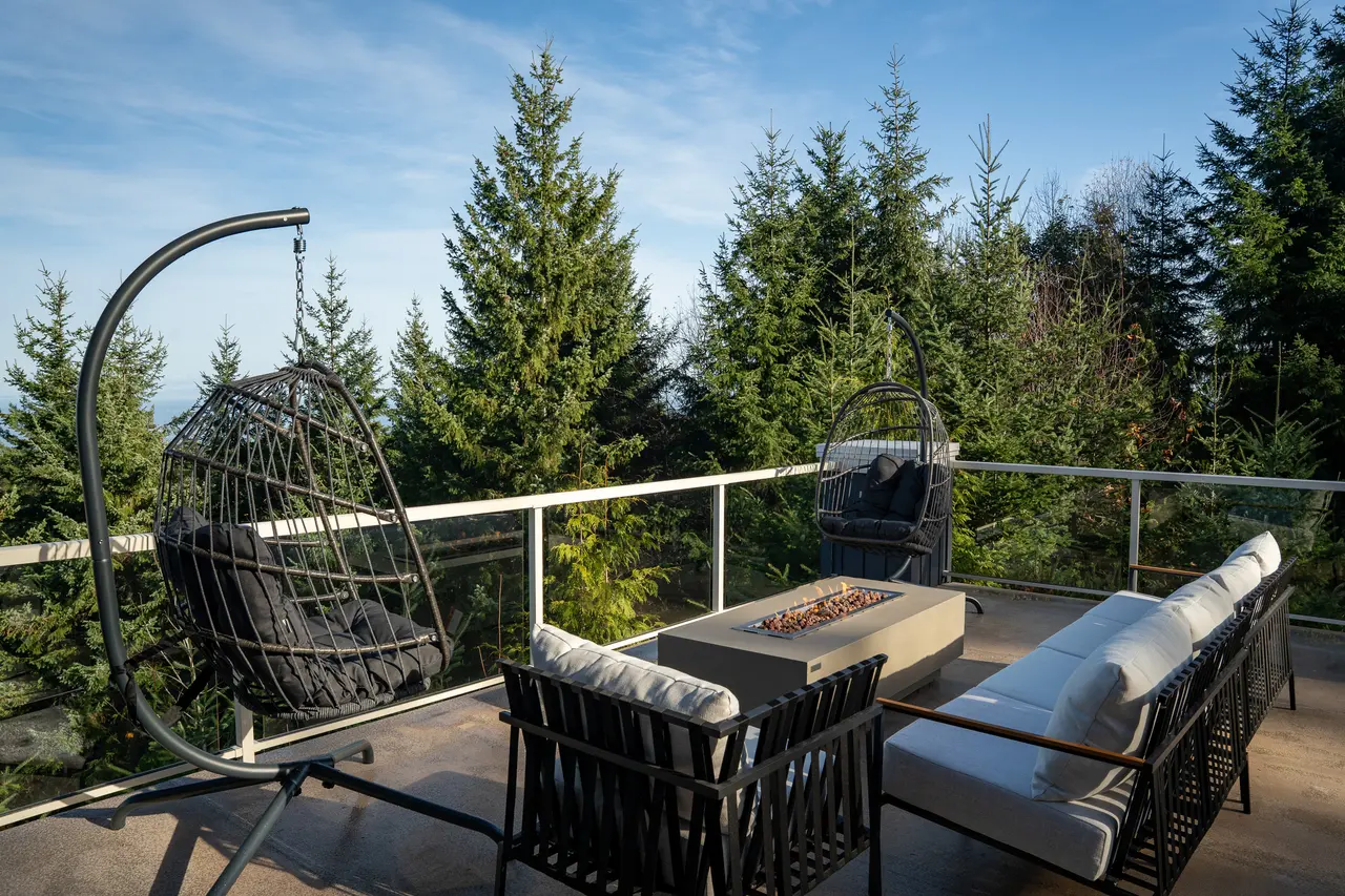 This is the 1,600 sq ft deck, your primary hub for morning coffee, evening cocktails, and non-stop sea and forest views.