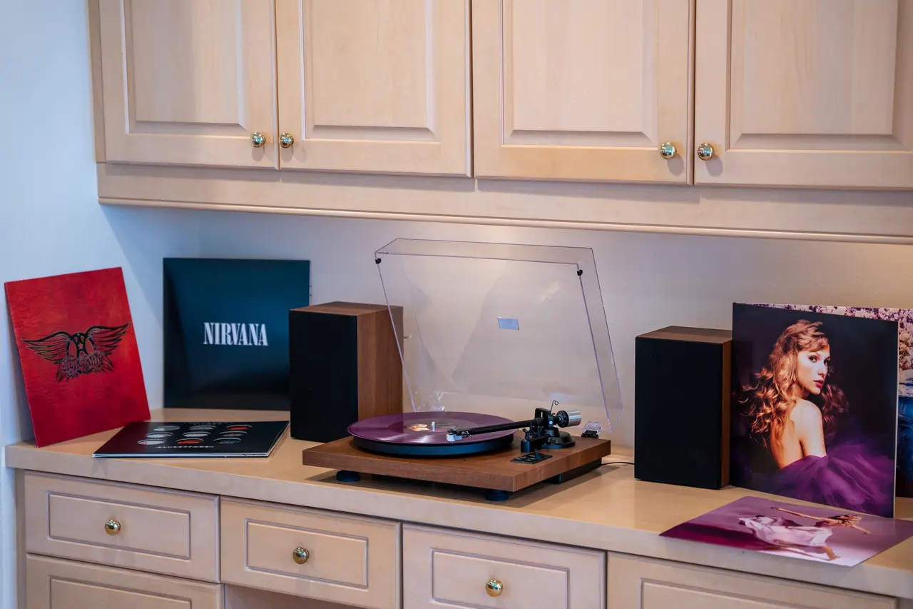 Set the mood with warm analog sound using our record player and curated vinyl collection.